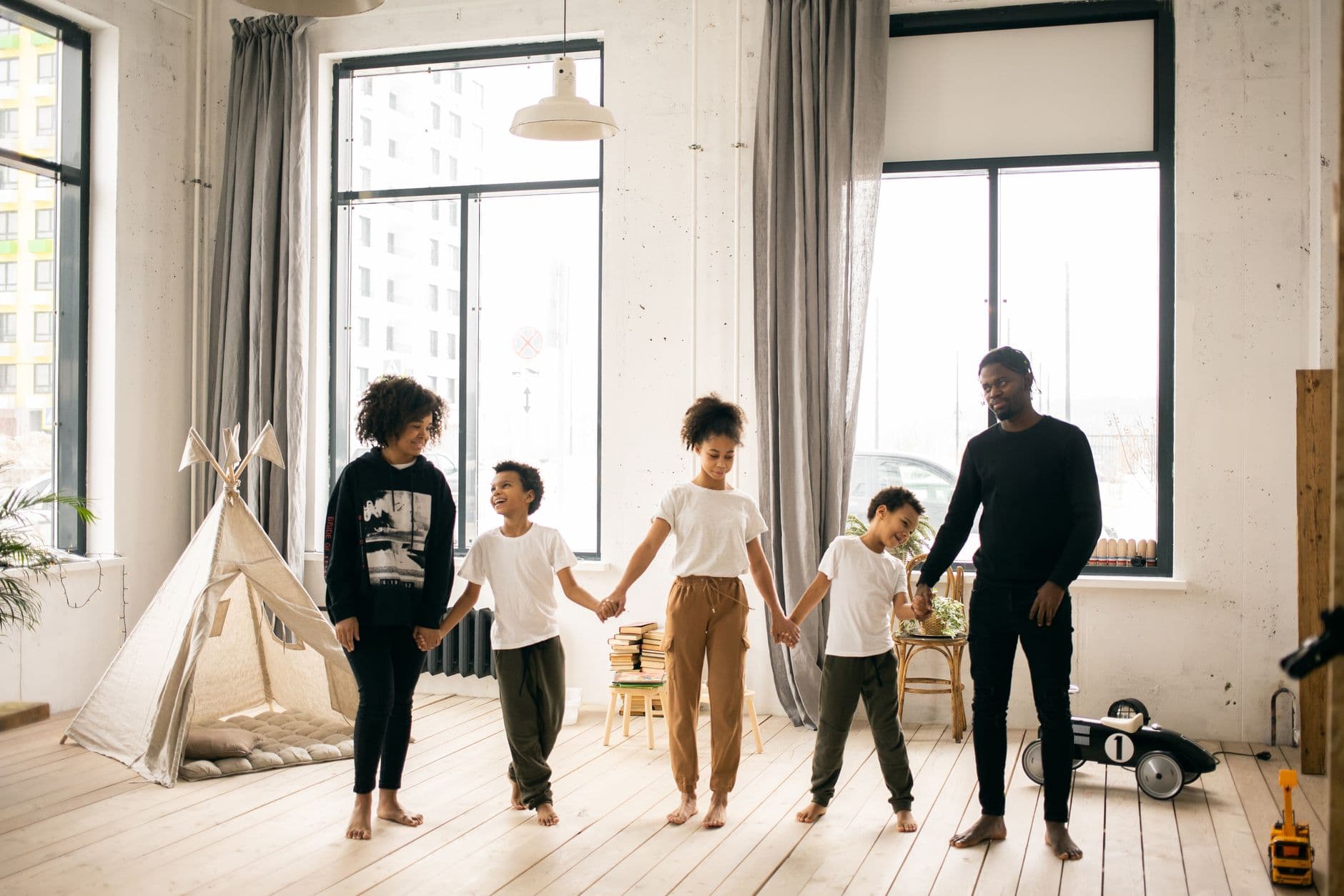 Happy family with young children enjoying time together at home